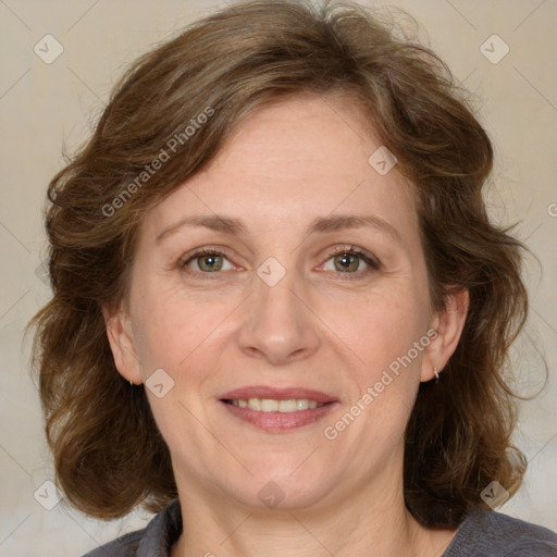 Joyful white adult female with medium  brown hair and blue eyes