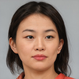 Neutral asian young-adult female with medium  brown hair and brown eyes