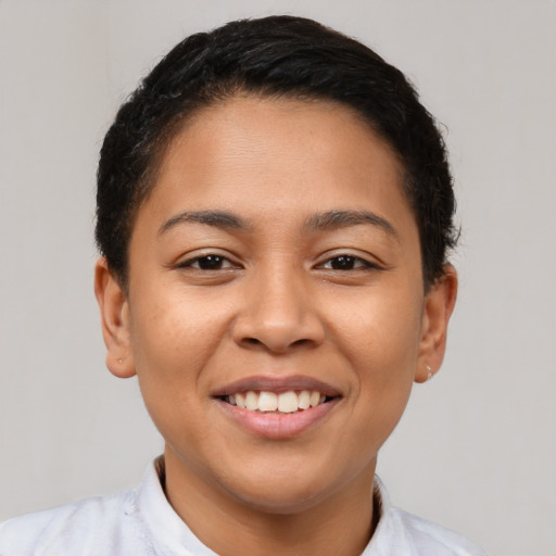 Joyful latino young-adult female with short  brown hair and brown eyes