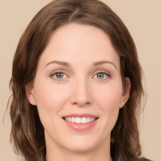 Joyful white young-adult female with medium  brown hair and green eyes