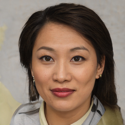 Joyful asian young-adult female with medium  brown hair and brown eyes