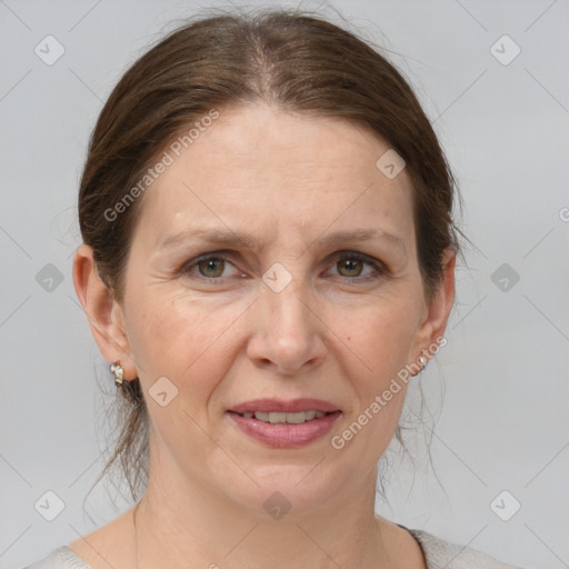 Joyful white adult female with medium  brown hair and grey eyes