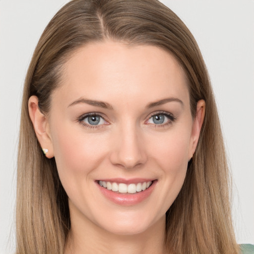 Joyful white young-adult female with long  brown hair and grey eyes