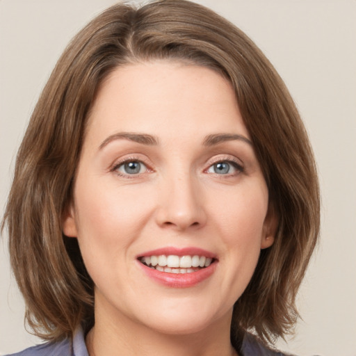 Joyful white young-adult female with medium  brown hair and green eyes