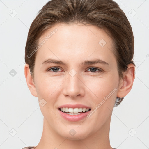 Joyful white young-adult female with short  brown hair and grey eyes