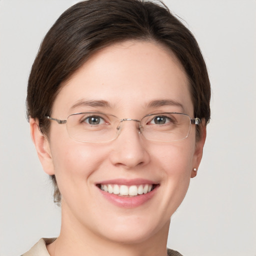 Joyful white young-adult female with short  brown hair and grey eyes