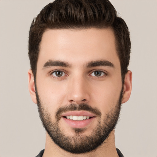 Joyful white young-adult male with short  brown hair and brown eyes