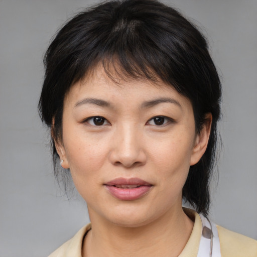 Joyful asian young-adult female with medium  brown hair and brown eyes