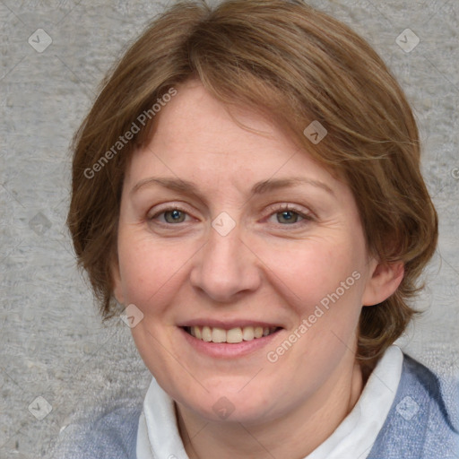 Joyful white adult female with medium  brown hair and blue eyes