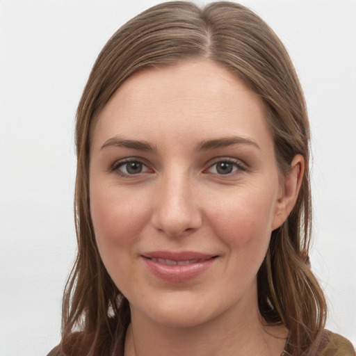 Joyful white young-adult female with long  brown hair and grey eyes