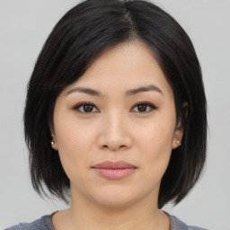 Joyful asian young-adult female with medium  black hair and brown eyes