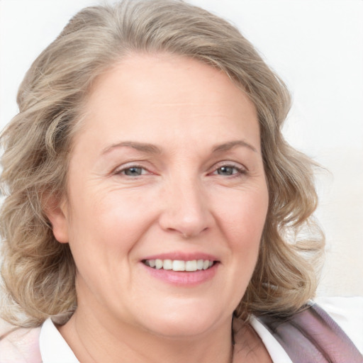 Joyful white adult female with medium  brown hair and blue eyes