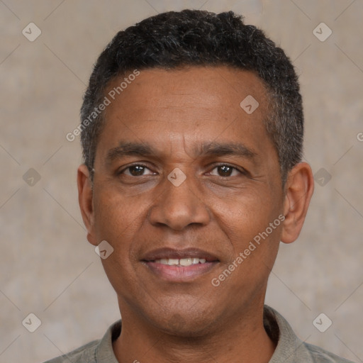 Joyful black adult male with short  black hair and brown eyes