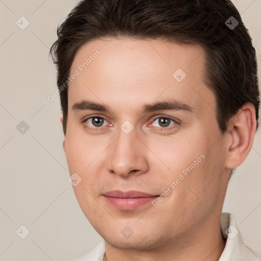 Joyful white young-adult male with short  brown hair and brown eyes