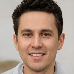 Joyful white young-adult male with short  brown hair and brown eyes