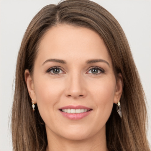 Joyful white young-adult female with long  brown hair and brown eyes