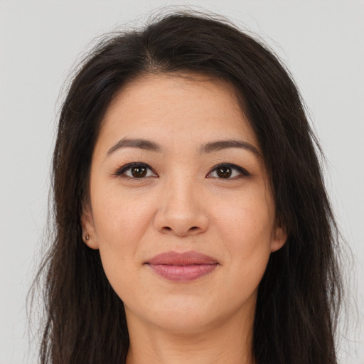 Joyful asian young-adult female with long  brown hair and brown eyes
