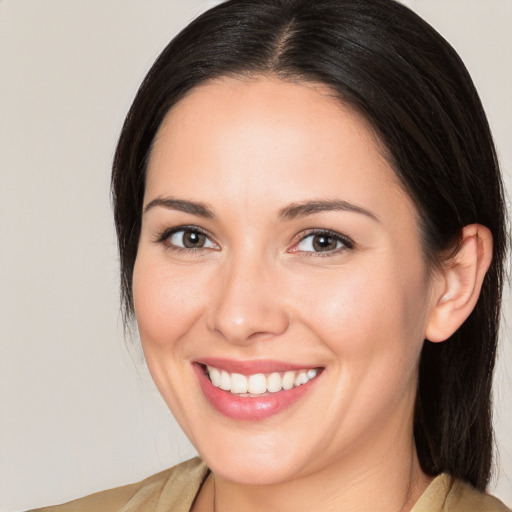 Joyful white young-adult female with medium  brown hair and brown eyes