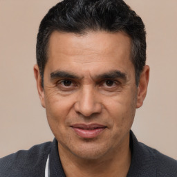 Joyful white adult male with short  black hair and brown eyes