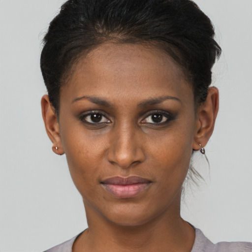 Joyful black young-adult female with short  brown hair and brown eyes
