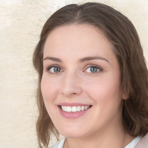 Joyful white young-adult female with medium  brown hair and blue eyes