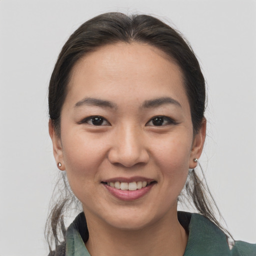 Joyful asian young-adult female with medium  brown hair and brown eyes