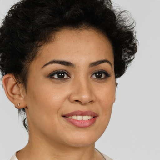 Joyful latino young-adult female with short  brown hair and brown eyes