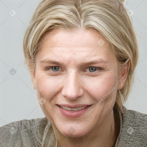 Joyful white adult female with medium  brown hair and blue eyes