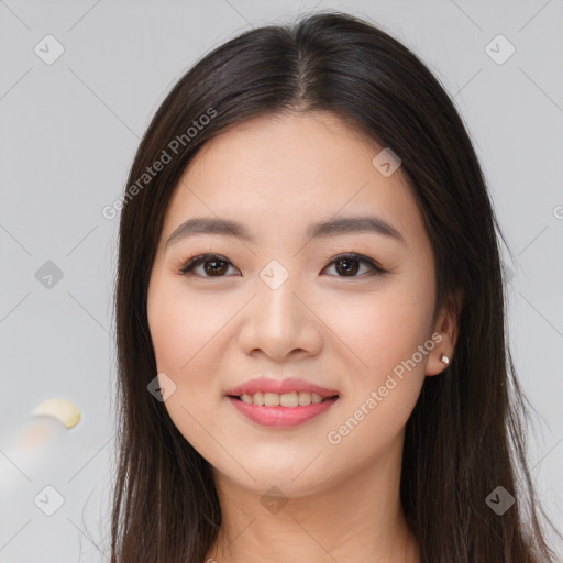 Joyful asian young-adult female with long  brown hair and brown eyes