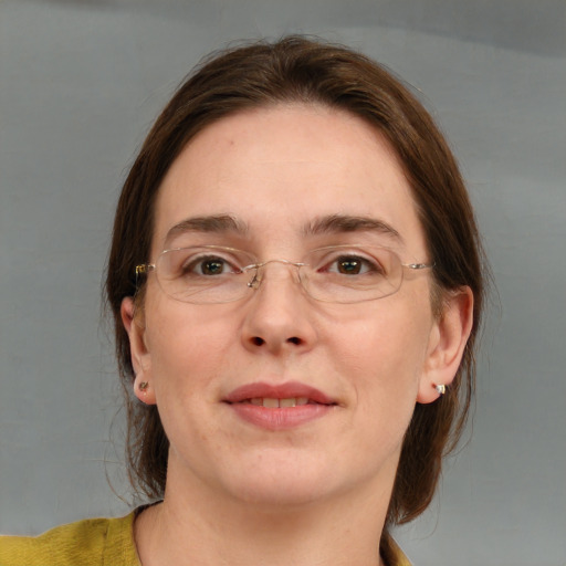 Joyful white young-adult female with medium  brown hair and blue eyes