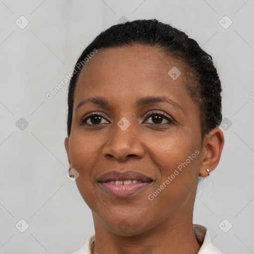 Joyful black young-adult female with short  brown hair and brown eyes