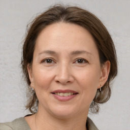 Joyful white adult female with medium  brown hair and brown eyes