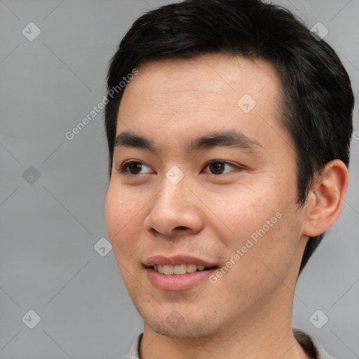 Joyful asian young-adult male with short  brown hair and brown eyes