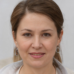 Joyful white adult female with medium  brown hair and brown eyes