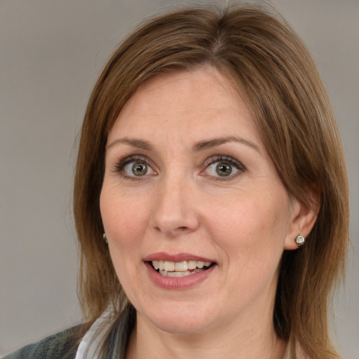 Joyful white adult female with medium  brown hair and brown eyes