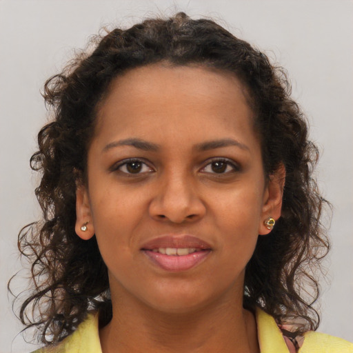 Joyful black young-adult female with medium  brown hair and brown eyes