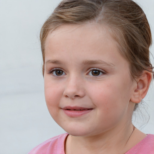 Joyful white child female with short  brown hair and brown eyes