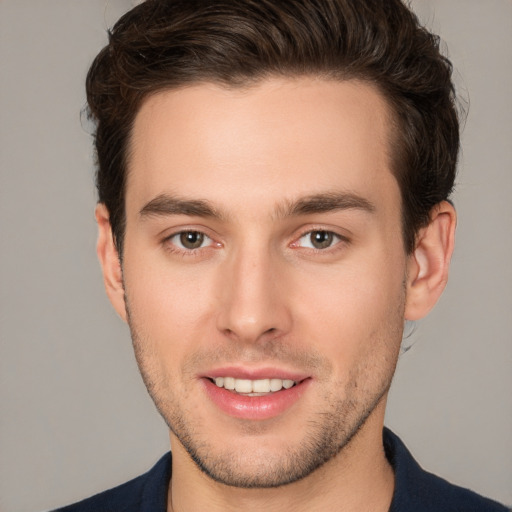 Joyful white young-adult male with short  brown hair and brown eyes