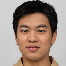 Joyful asian young-adult male with short  black hair and brown eyes