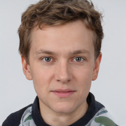 Joyful white young-adult male with short  brown hair and grey eyes