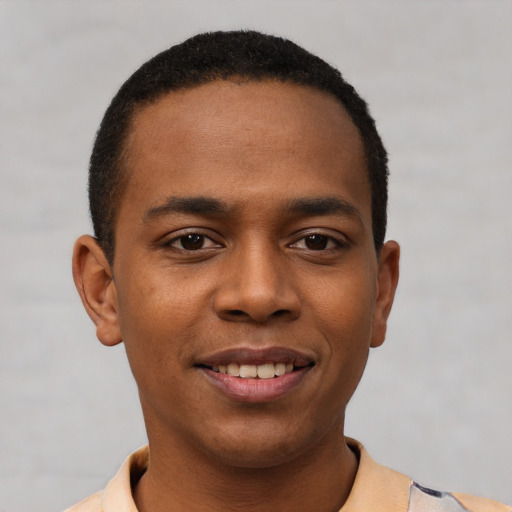 Joyful black young-adult male with short  black hair and brown eyes