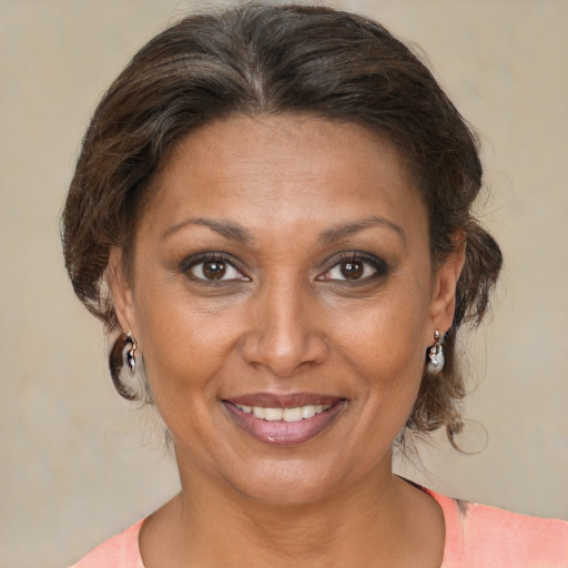 Joyful white adult female with medium  brown hair and brown eyes