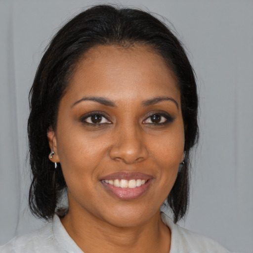 Joyful black young-adult female with medium  brown hair and brown eyes