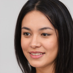 Joyful asian young-adult female with long  brown hair and brown eyes