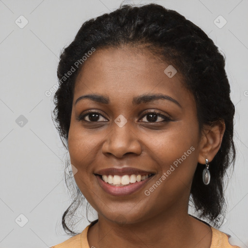 Joyful black young-adult female with long  black hair and brown eyes