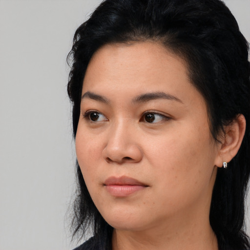 Joyful asian young-adult female with long  black hair and brown eyes
