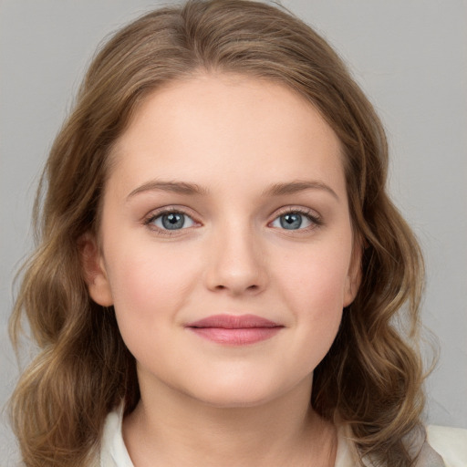 Joyful white child female with medium  brown hair and grey eyes