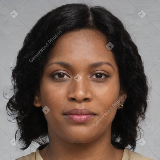 Joyful black young-adult female with long  black hair and brown eyes