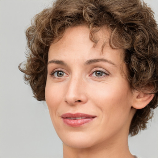 Joyful white adult female with medium  brown hair and green eyes