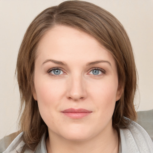 Joyful white young-adult female with medium  brown hair and blue eyes